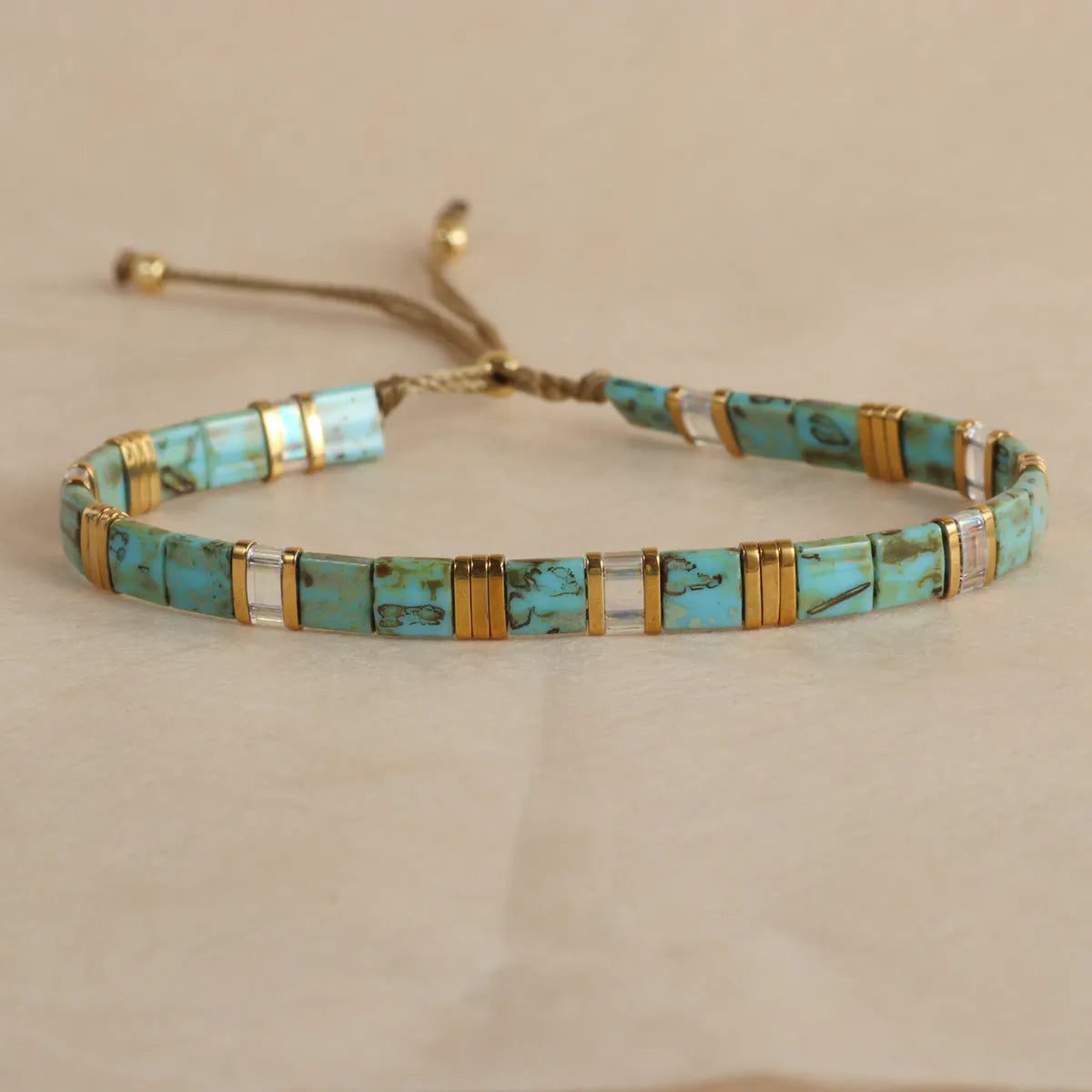 Geometric glass pull bead bracelet in milky white, black, green, blue or red with round decorative elements