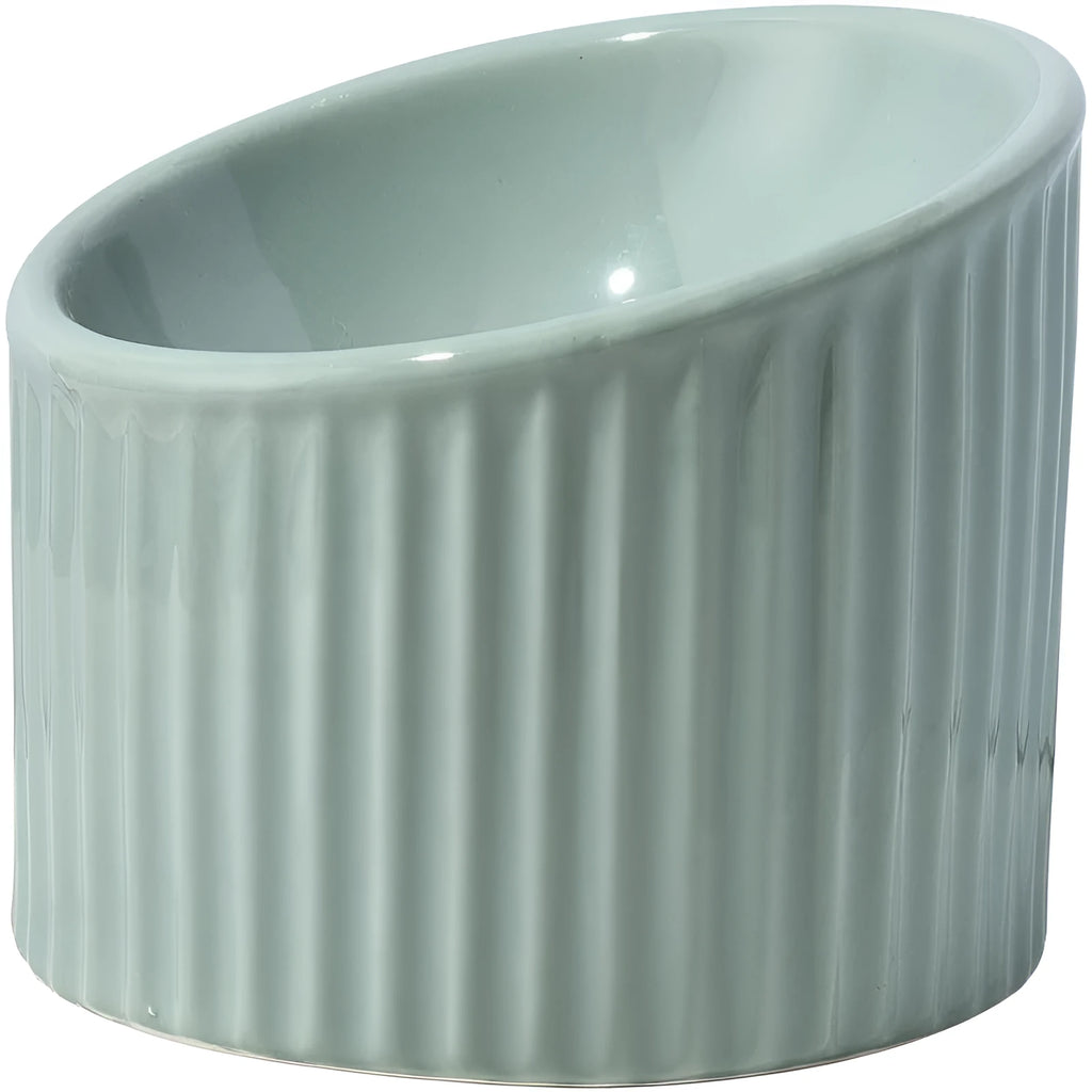 Dark green ceramic elevated cat bowl with round, whisker-friendly shape on a tilted base.