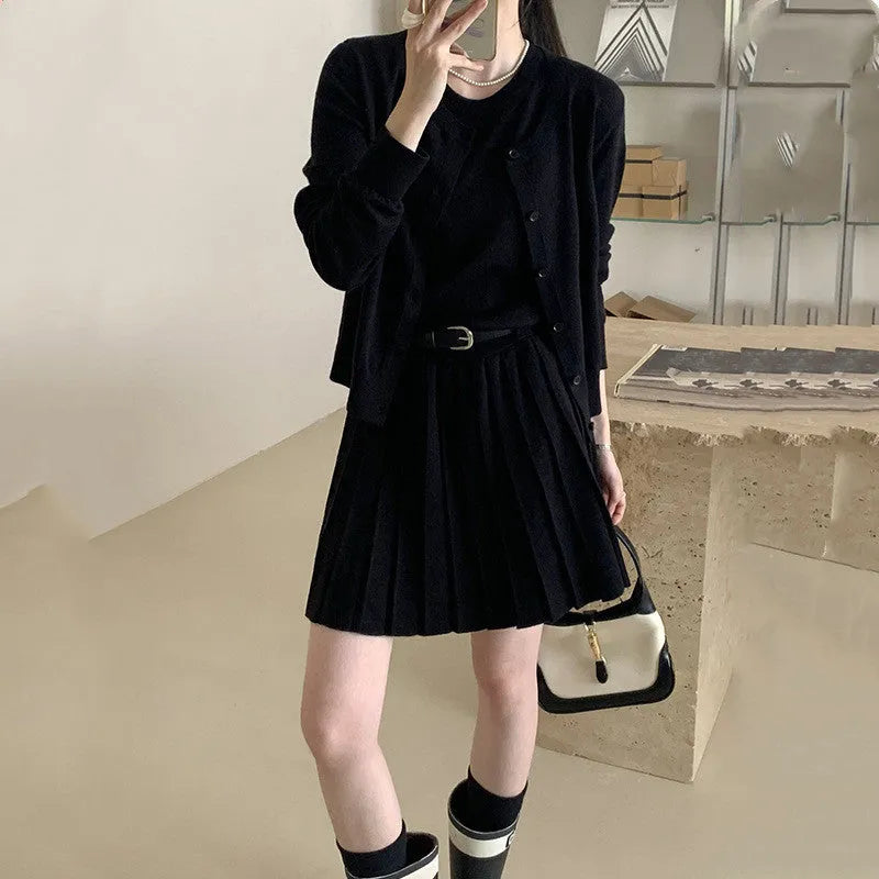 Women's art retro knitted two-piece set featuring a pleated vest skirt with 3D pattern and a long-sleeved cardigan.