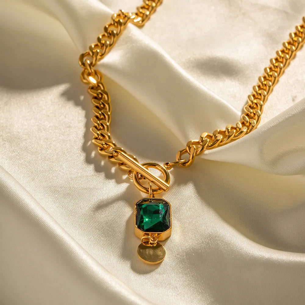 Gold electroplated titanium steel necklace with geometric pendant and emerald zircon stone on Cuban link chain