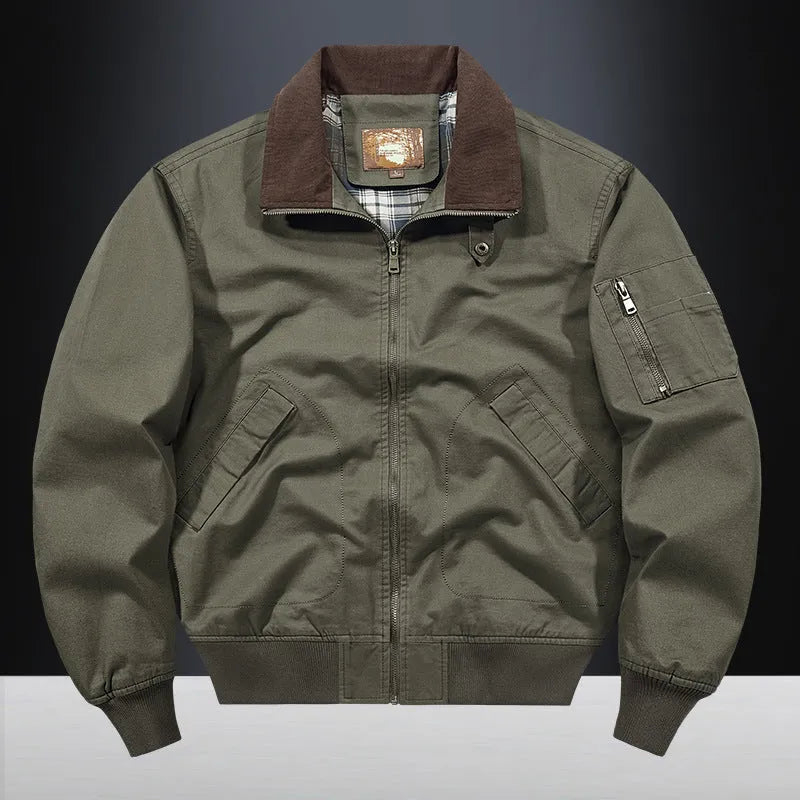 Men's beige washed cotton baseball style flight jacket on a hanger, showing classic design.