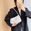 Butterfly chain underarm bag in horizontal square shape with detachable strap and organised interior