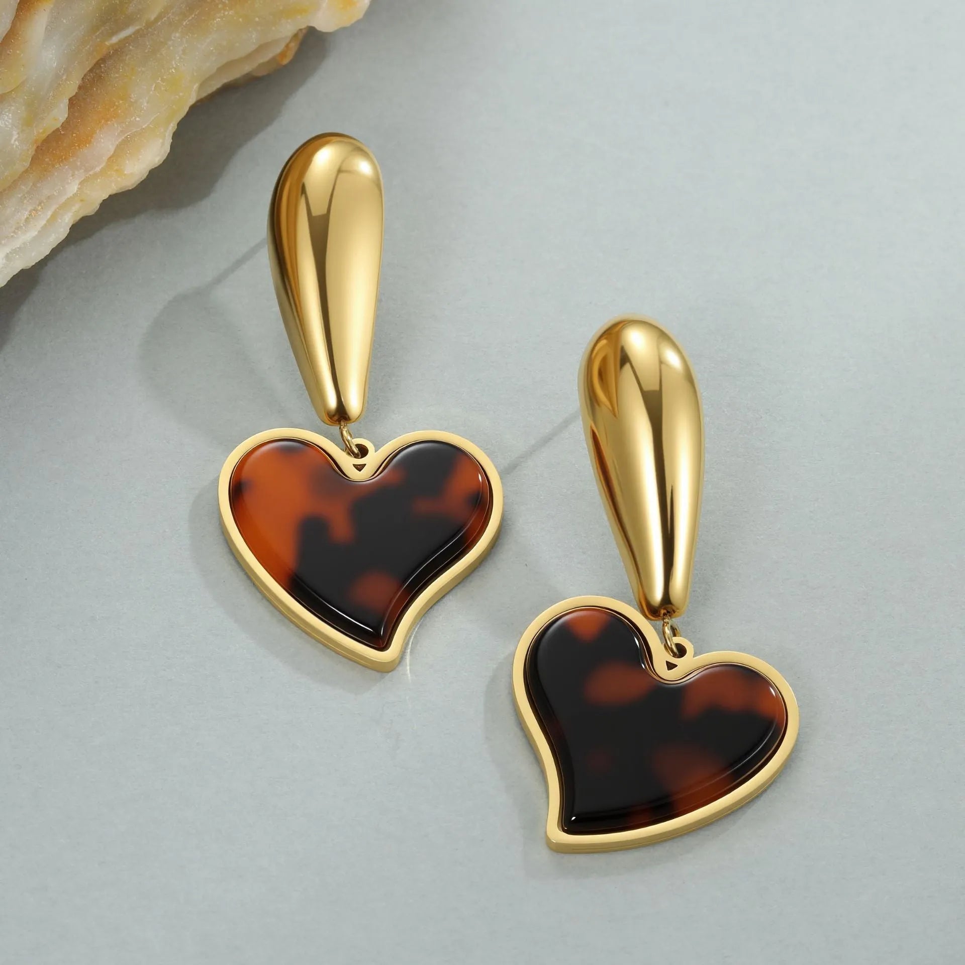 Women's tortoiseshell colour earrings with 18K gold plating, showing heart-shaped and floral geometric designs on a stainless steel base.