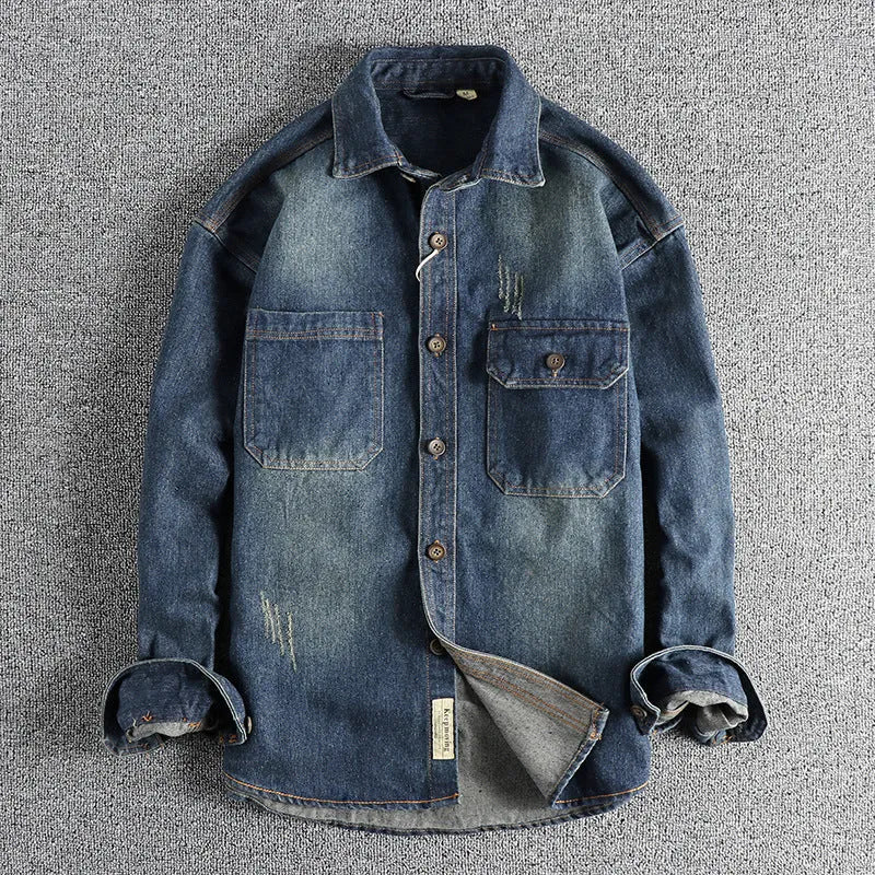 Men's light blue vintage wash denim shirt with loose fit and long sleeves on hanger