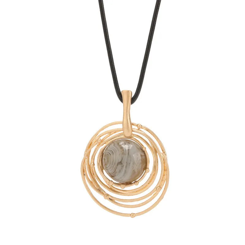 Gold geometric plaid pendant on a snakeskin-textured chain, adjustable sweater necklace.