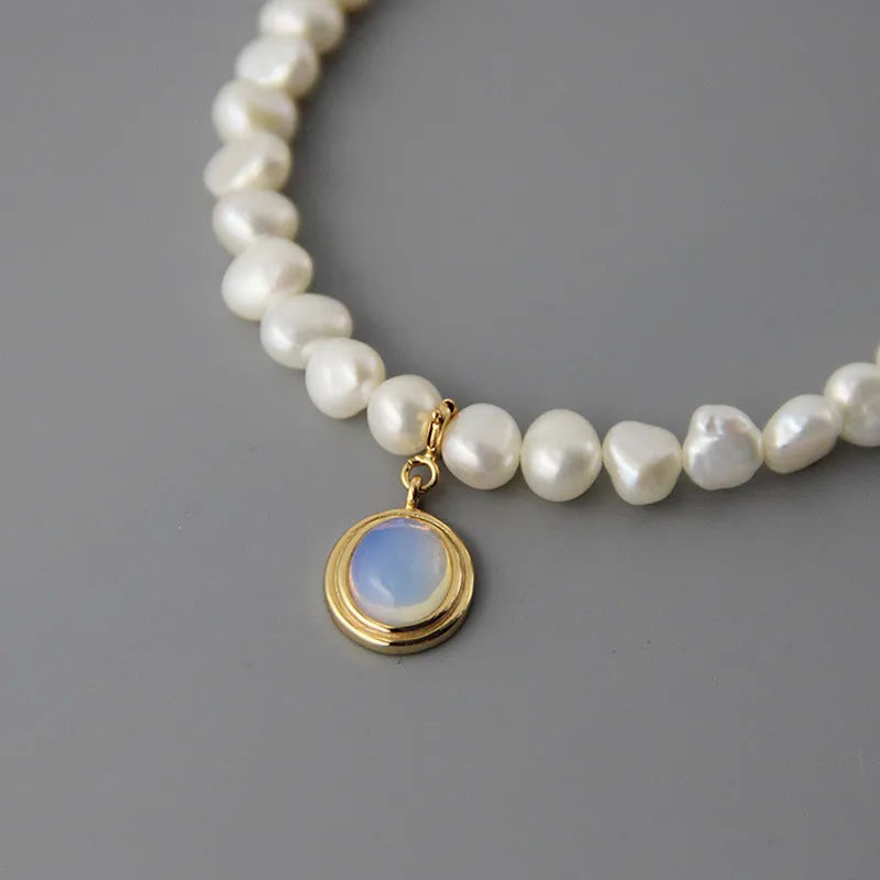 Geometric silver pendant pearl necklace with adjustable chain on white background
