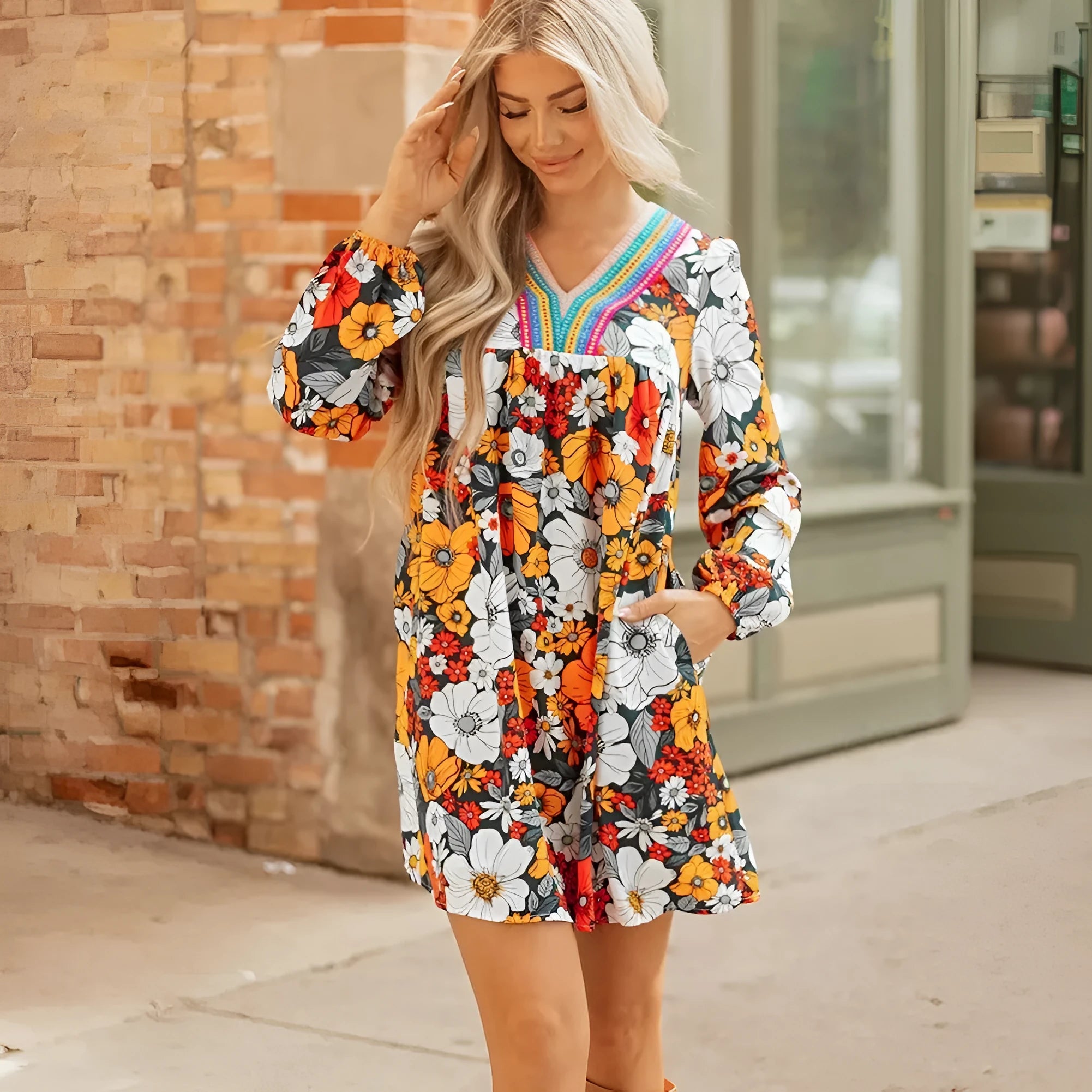 Orange floral print mini dress with V-neck, long sleeves, and striped lace detailing