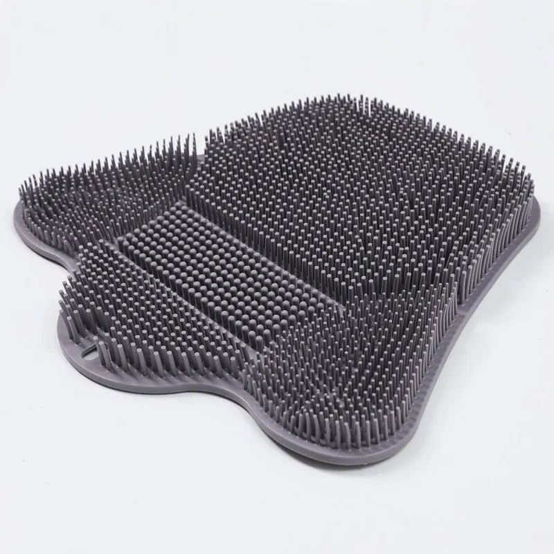 Blue silicone bath massage cushion mat for body scrubbing, shown on a bathroom surface.