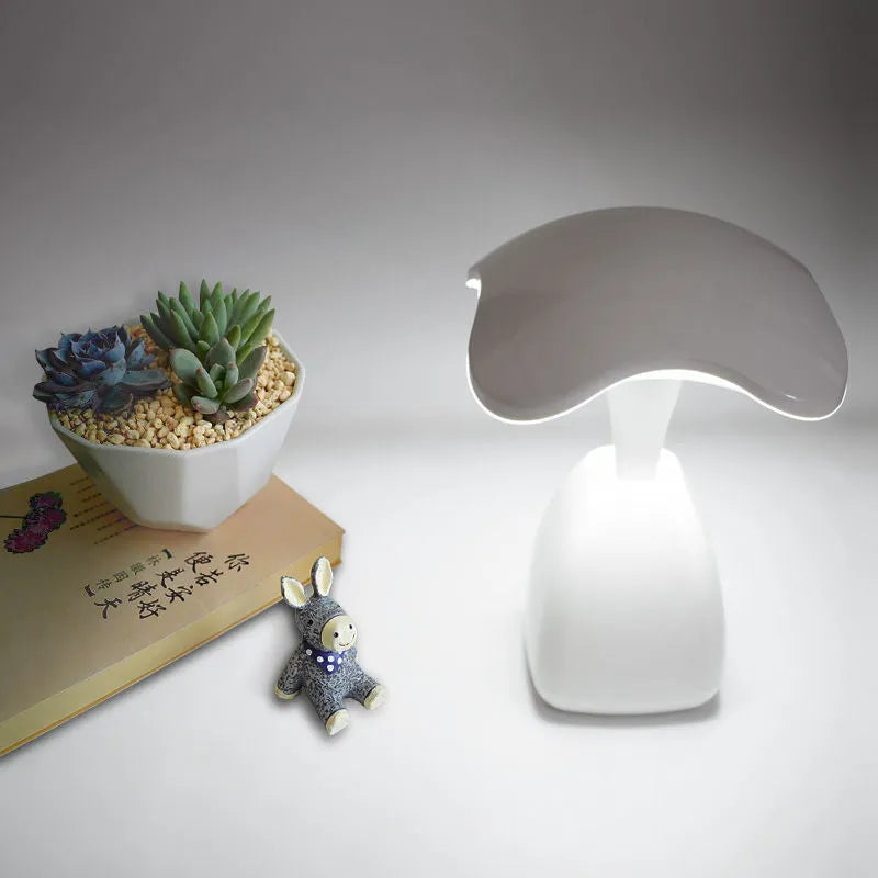 White plastic LED desk lamp with touch controls and built-in battery for bedside use
