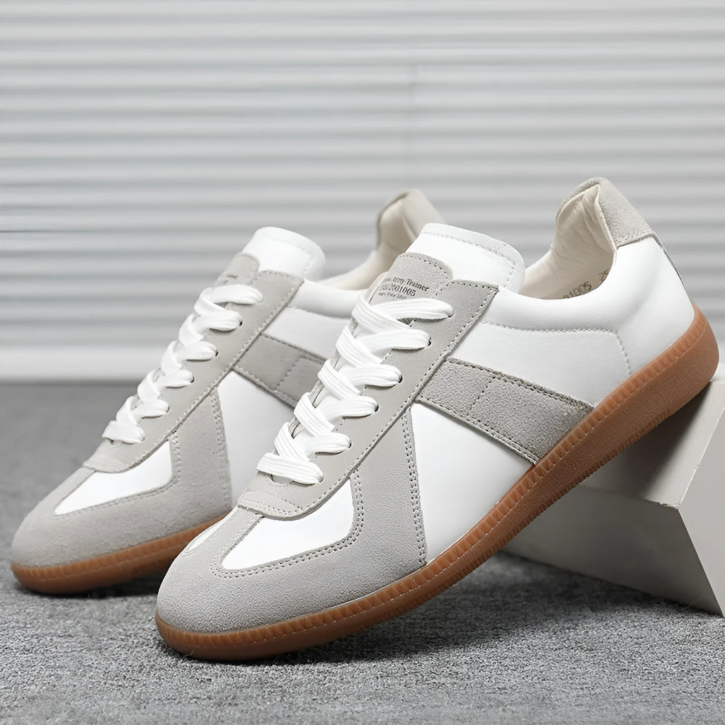 White Japanese retro low-top sneakers with matte finish and visible stitching on a rubber sole.