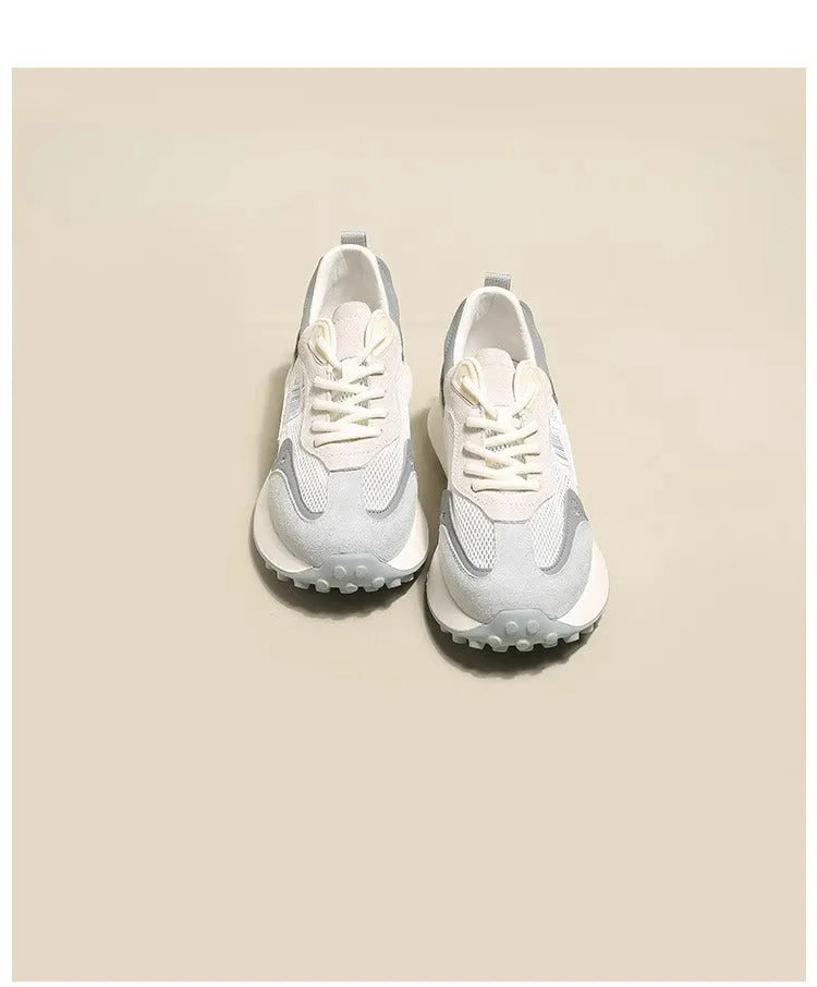 Women's grey and pink retro low-top sneaker with round toe and rubber sole.