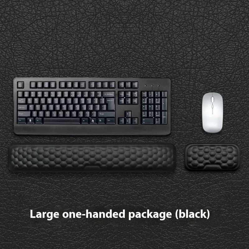 Memory foam mouse wrist pad with silicone bottom in black cloth cover on computer desk