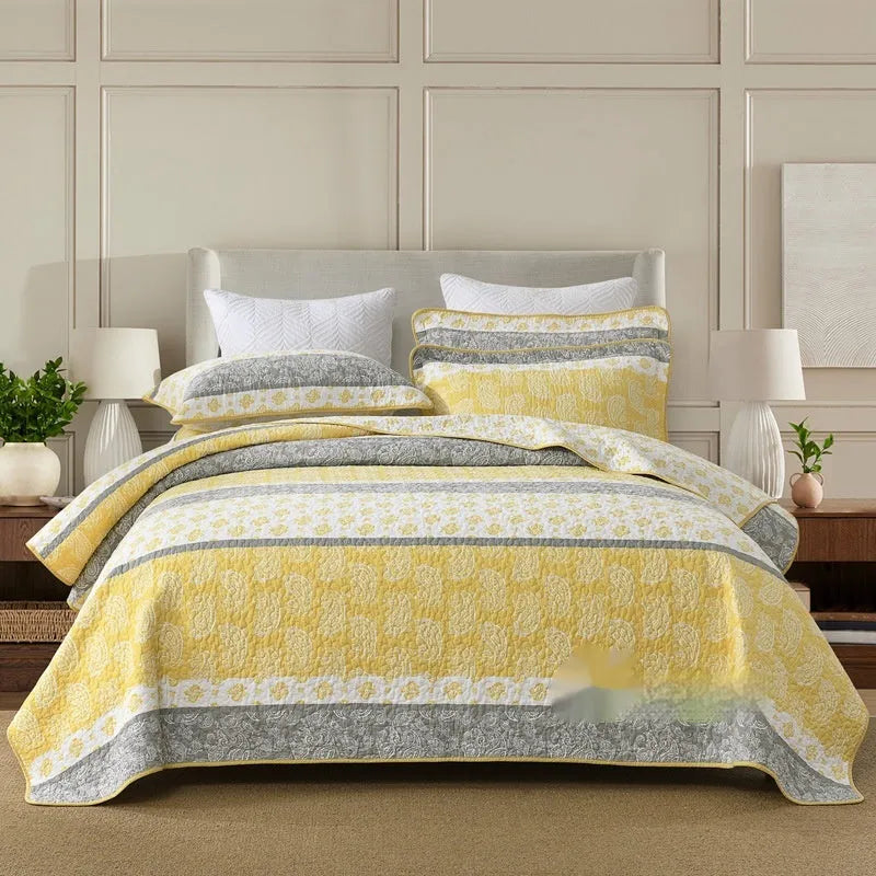 Quilted cotton bed cover set with printed pattern including bedspread and two pillowcases