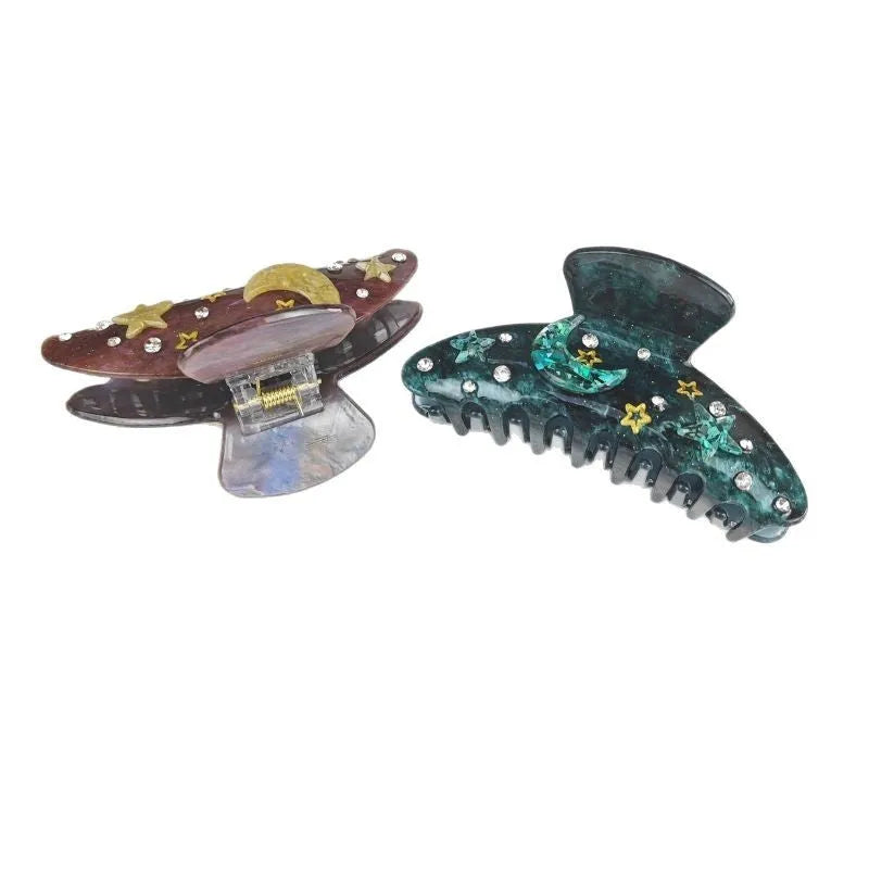 Oversized women's barrette with blue star moon starry sky pattern on a cellulose acetate clip.