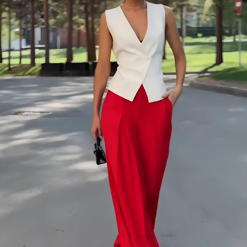 Women's beige two-piece set with deep V-neck sleeveless top and high-waist wide-leg trousers.