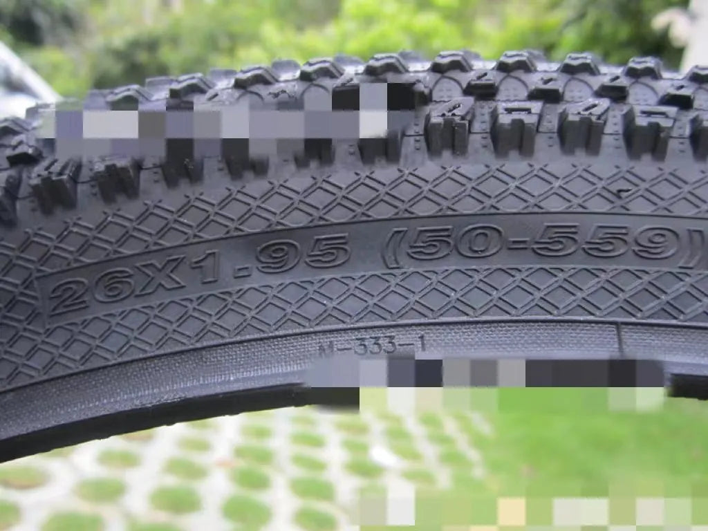 Ultralight mountain bike tyre with reinforced sidewall shown in black, suitable for 26, 27.5 or 29 inch wheels