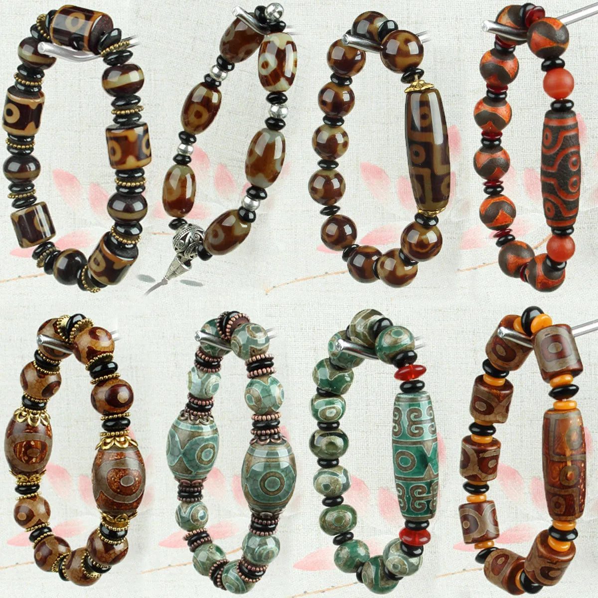 Distressed agate Tibetan bead bracelet with three-eye motifs and polished finish.