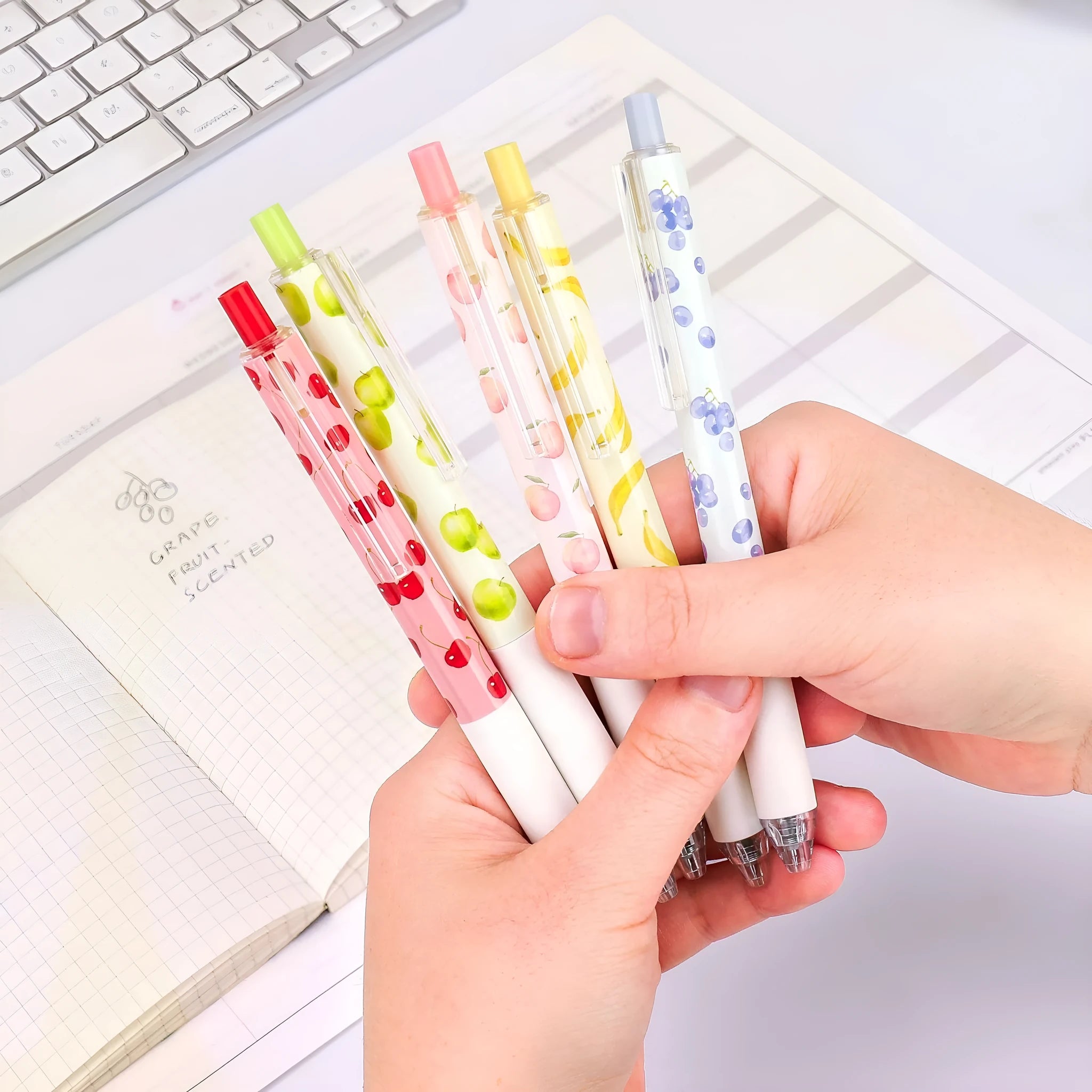 Three scented fruit flavoured press-action pens with 0.5mm black ink refills
