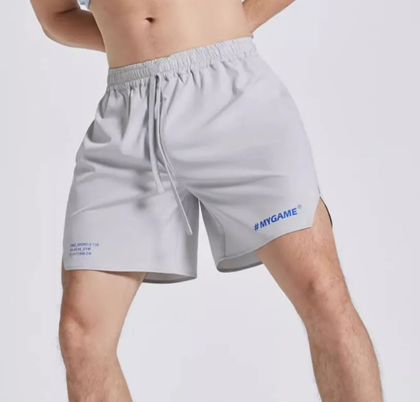 Men's blue training shorts with moisture-wicking fabric on a grey background.