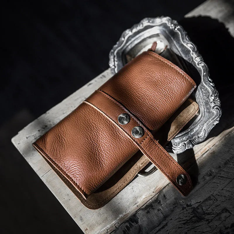 Handmade vintage bifold wallet in genuine cow leather showing tape extraction closure