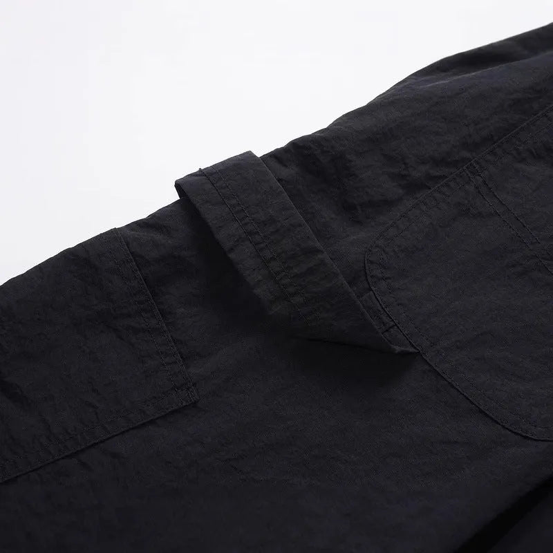 Black baggy paratrooper pants with an elastic waistband on a neutral background.