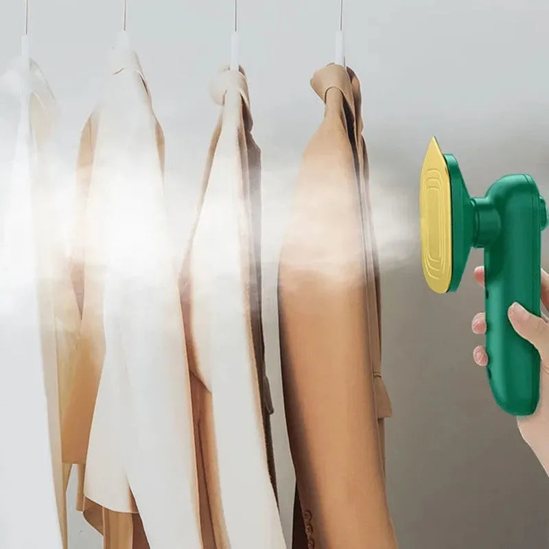 Dark green portable hanging steam iron machine with ceramic panel, shown for scale next to a mobile phone.