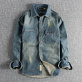 Men's light blue vintage wash denim shirt with loose fit and long sleeves on hanger