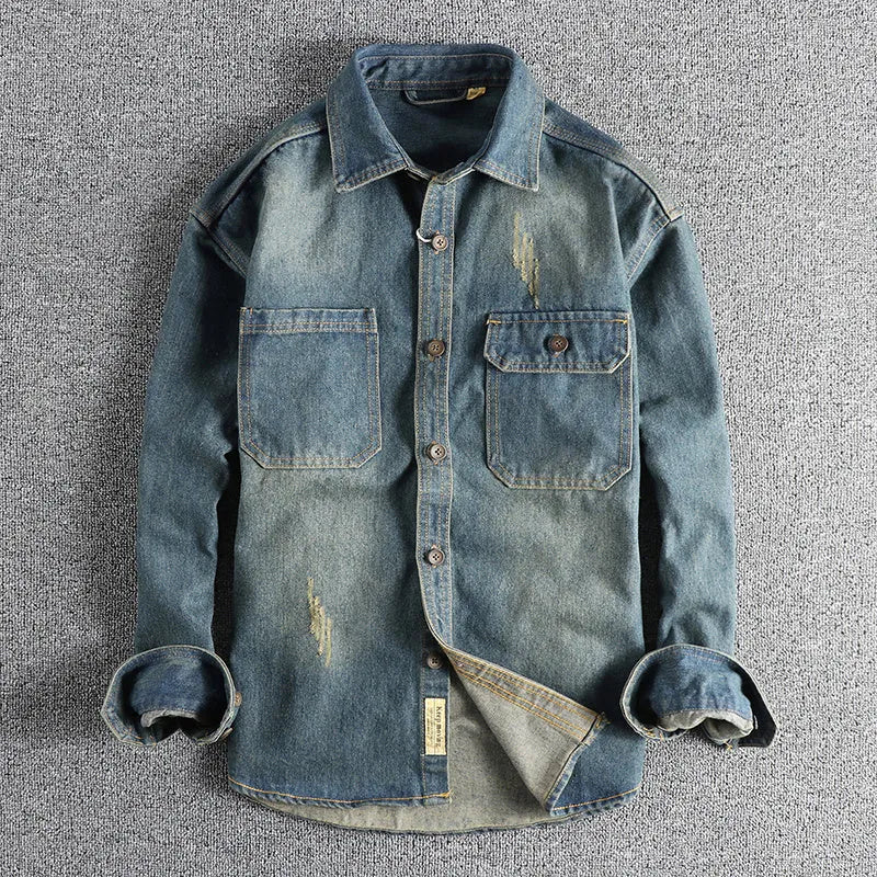 Men's light blue vintage wash denim shirt with loose fit and long sleeves on hanger