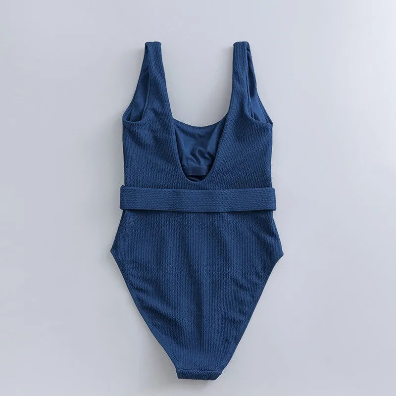 Navy blue women's one-piece triangle swimsuit with chest pads on a mannequin.