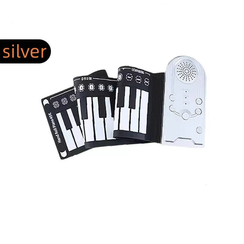 Portable black folding electronic keyboard rolled up next to its control panel and cable.