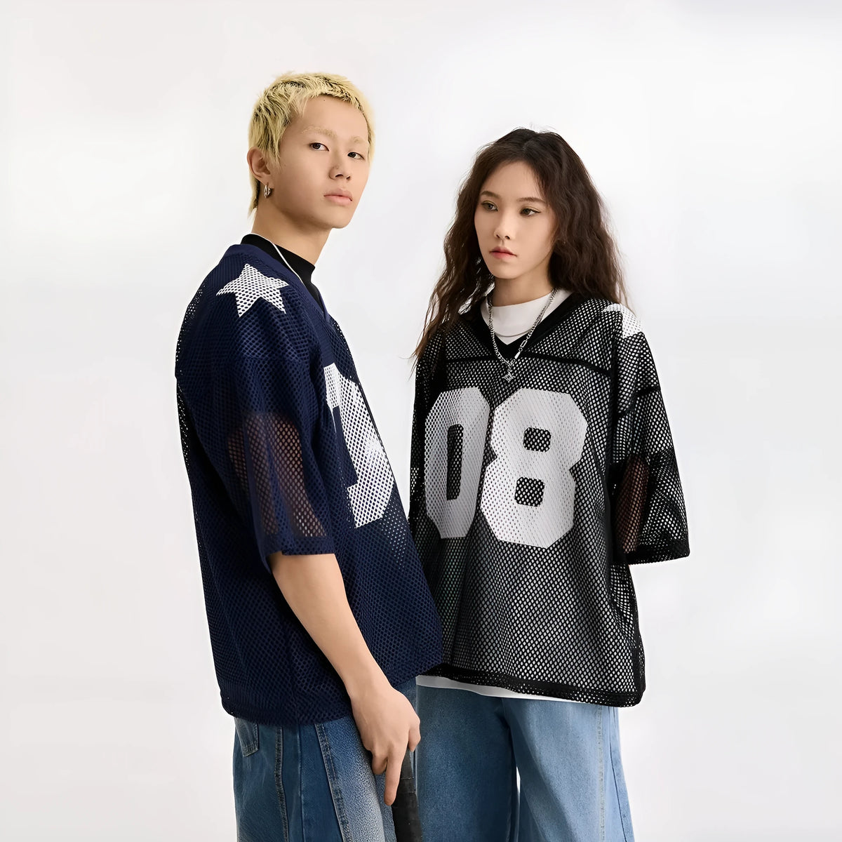 Black polyester pullover shirt with letter pattern design and short sleeves on a hanger
