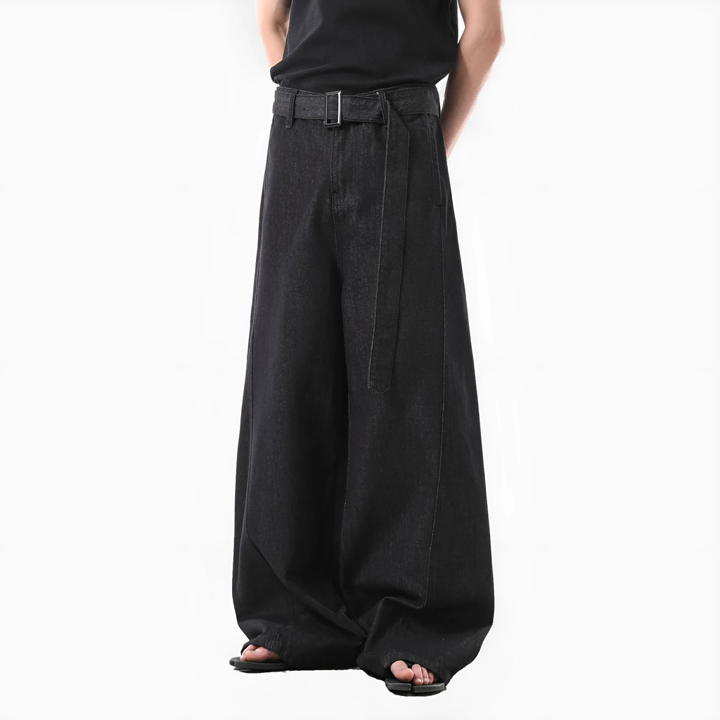 Black high-waist straight-leg jeans with gold details on a denim background.