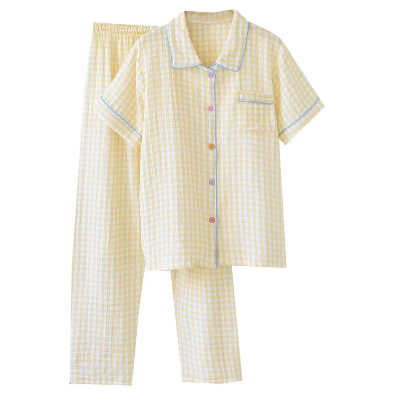 Women's loose-fit cotton gauze pyjama set with short sleeves and trousers in a floral or plaid pattern.