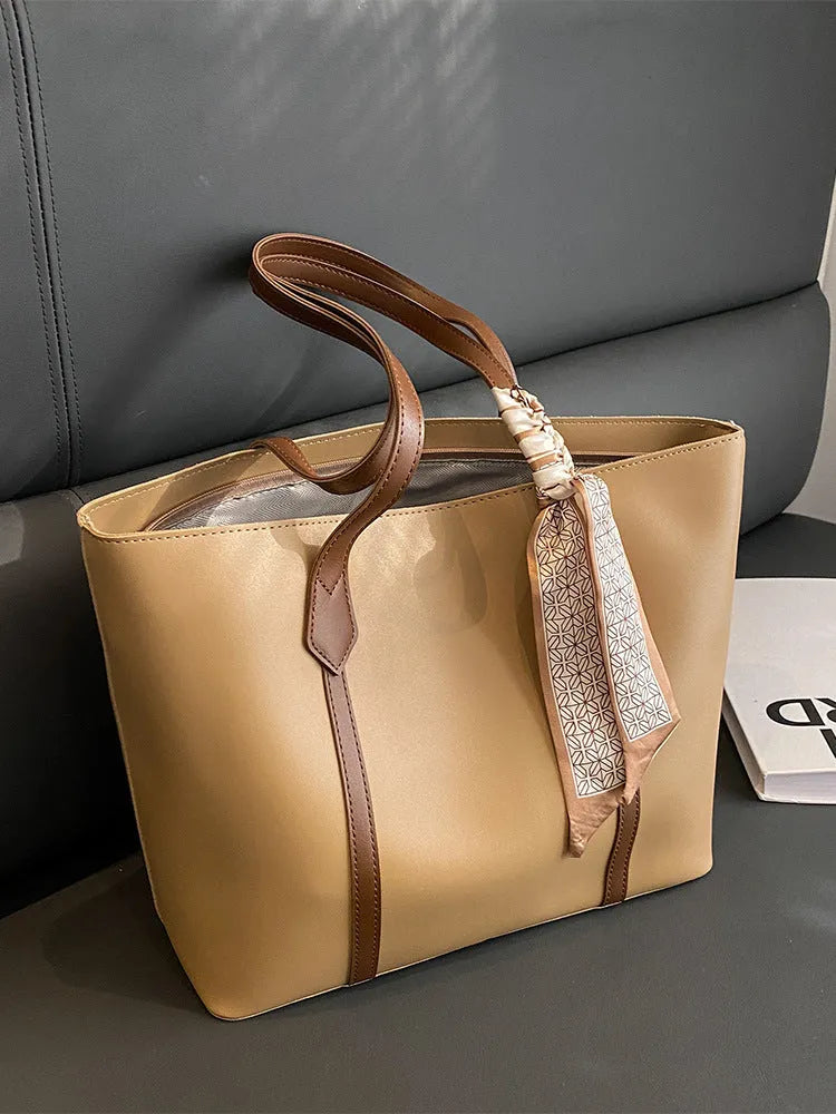 Women's soft large capacity tote bucket shoulder bag in khaki colour showing crossbody strap and front sandwich pocket.