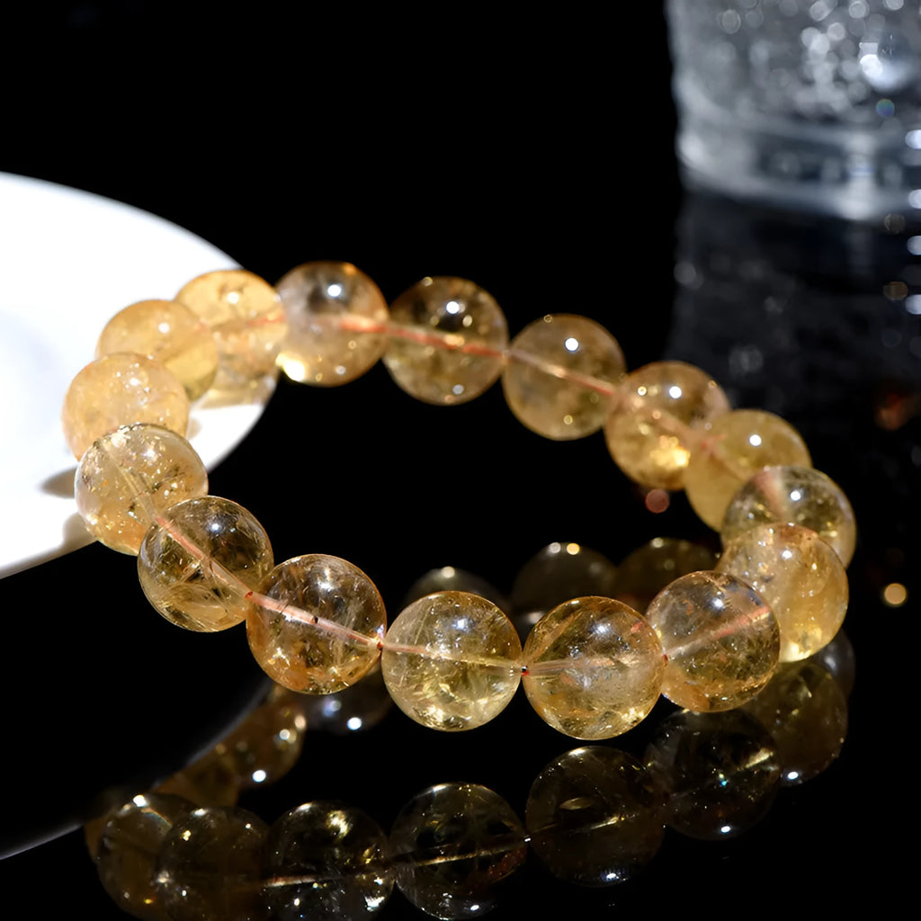 Natural yellow citrine gemstone bracelet showing geometric cut beads on a string.