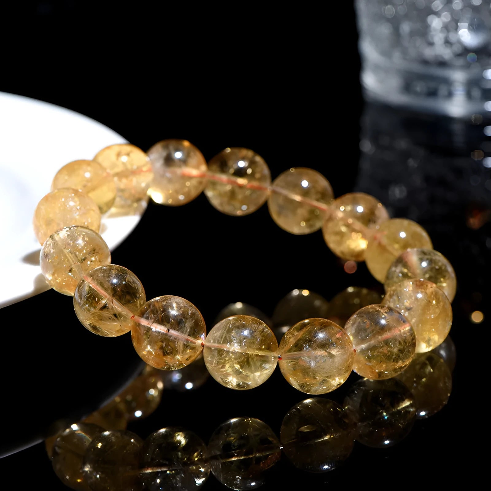 Natural yellow citrine gemstone bracelet showing geometric cut beads on a string.
