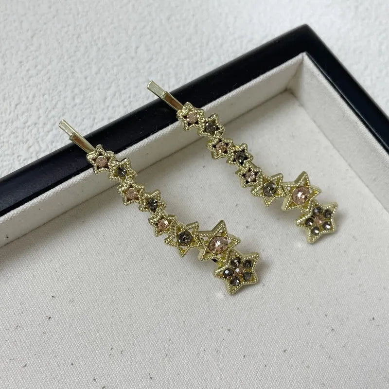 Gold electroplated rhinestone barrette with star design and side clip for bangs