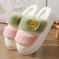 Pink and blue thermal cotton slippers with plush upper and cashmere lining, shown on a foot.