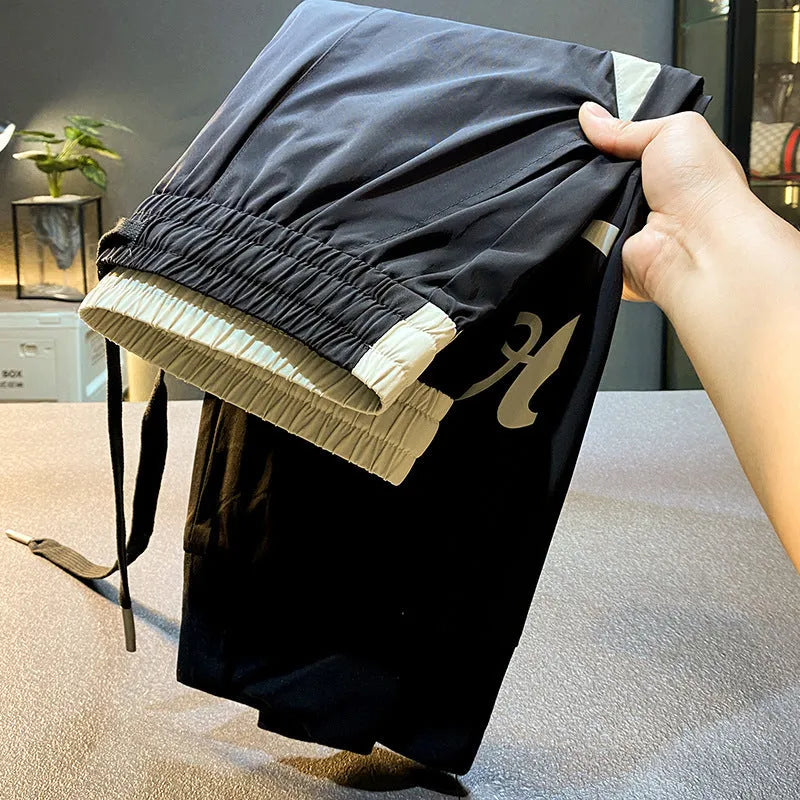 Men's black cropped ankle banded trousers in ultra-thin ice silk cotton fabric
