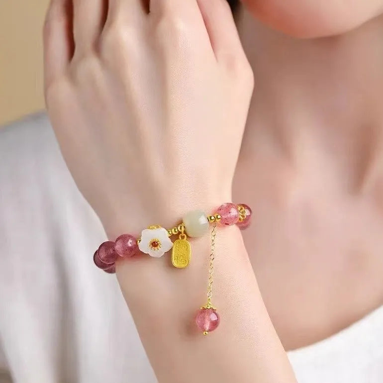 Handmade strawberry quartz crystal bracelet for women showing natural bead details on wrist