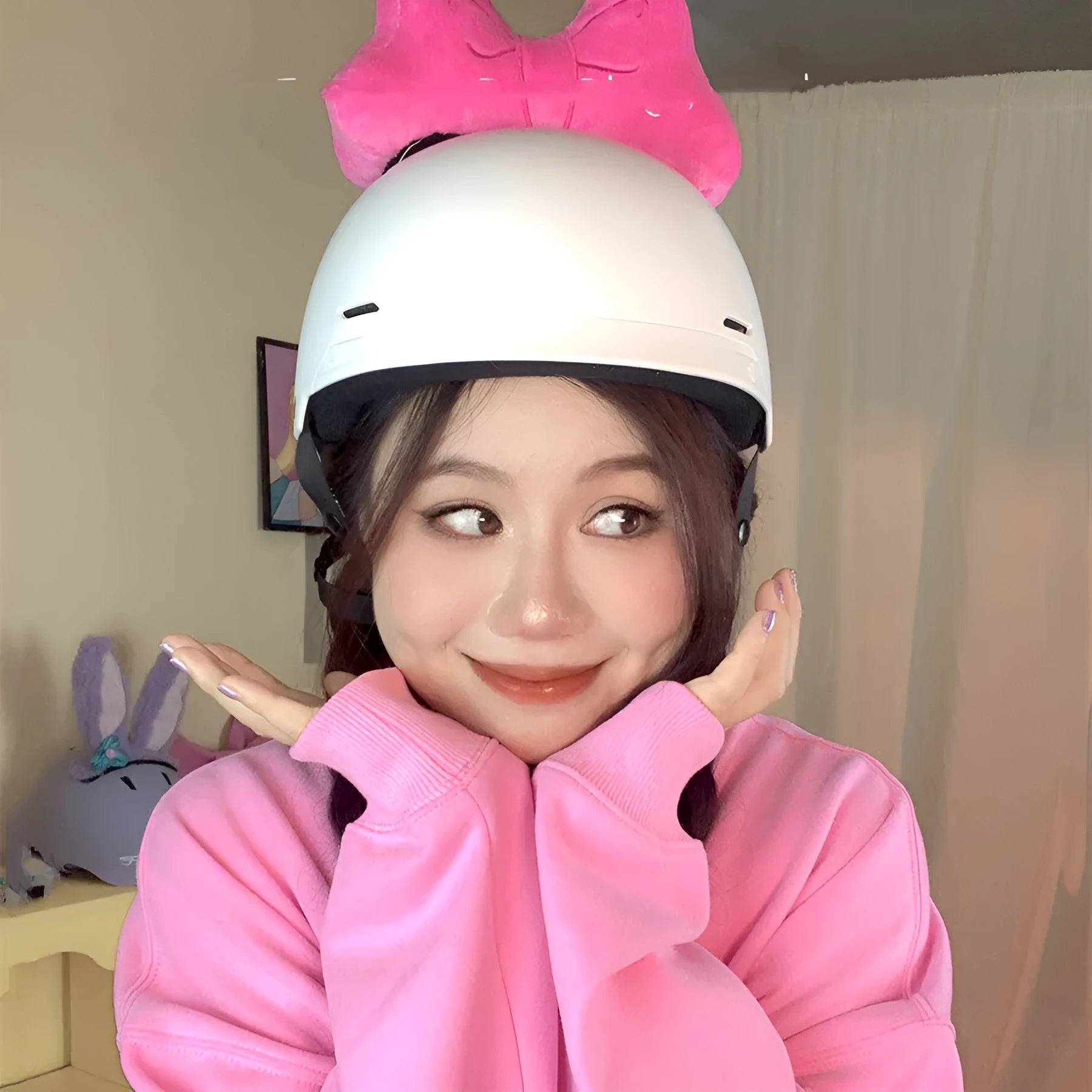 A soft plush bow tie helmet decoration shown in red, peach pink, and rose pink colours.