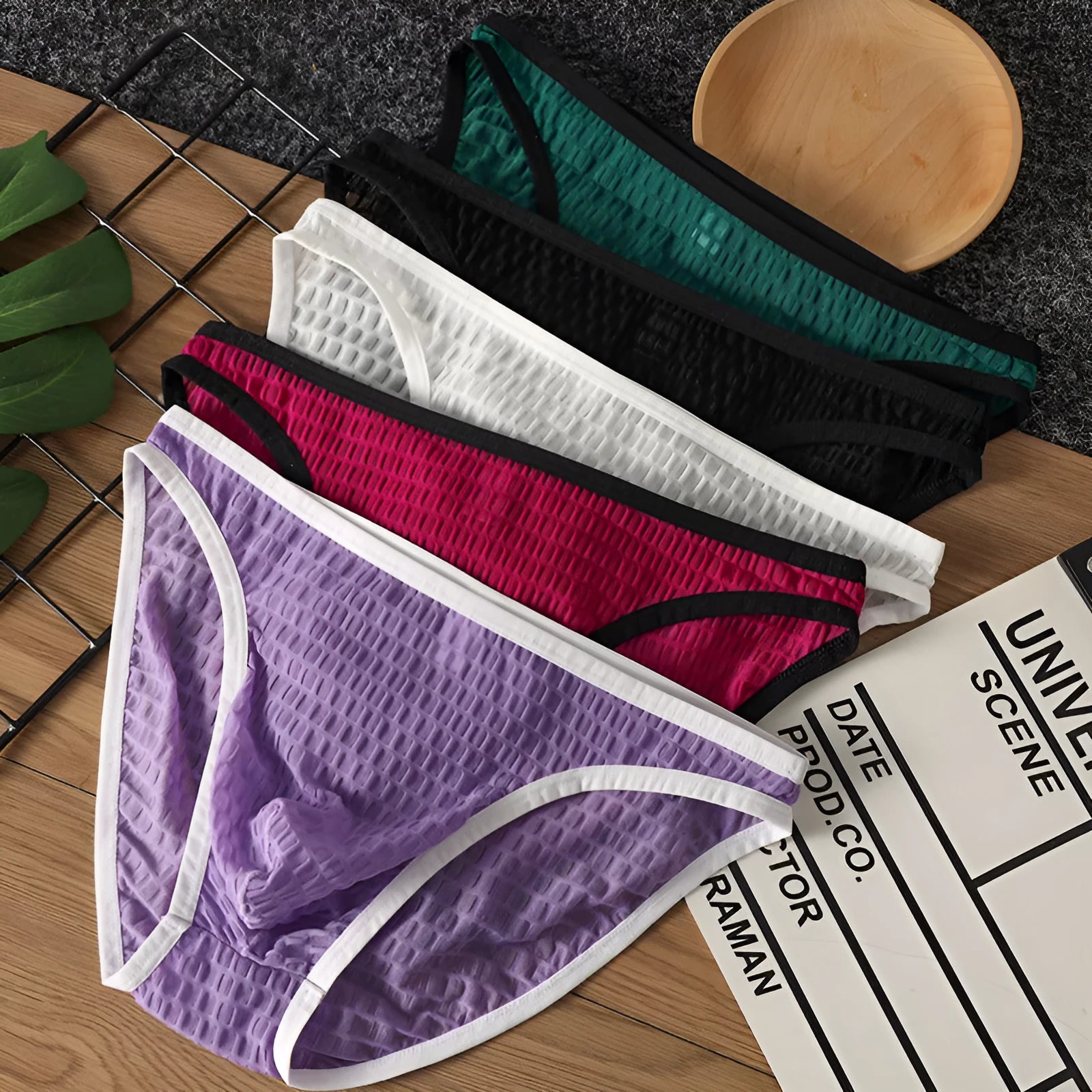 Men's low waist transparent lace underwear in black, shown flat