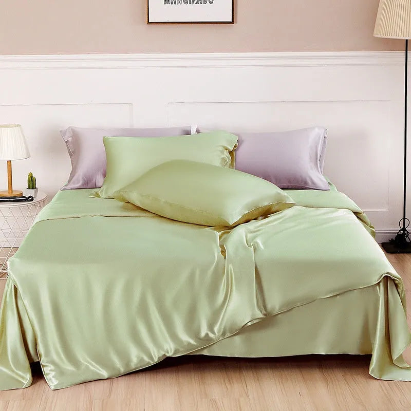 Solid colour silk duvet cover shown in Lotus Pink, laid flat on a bed.