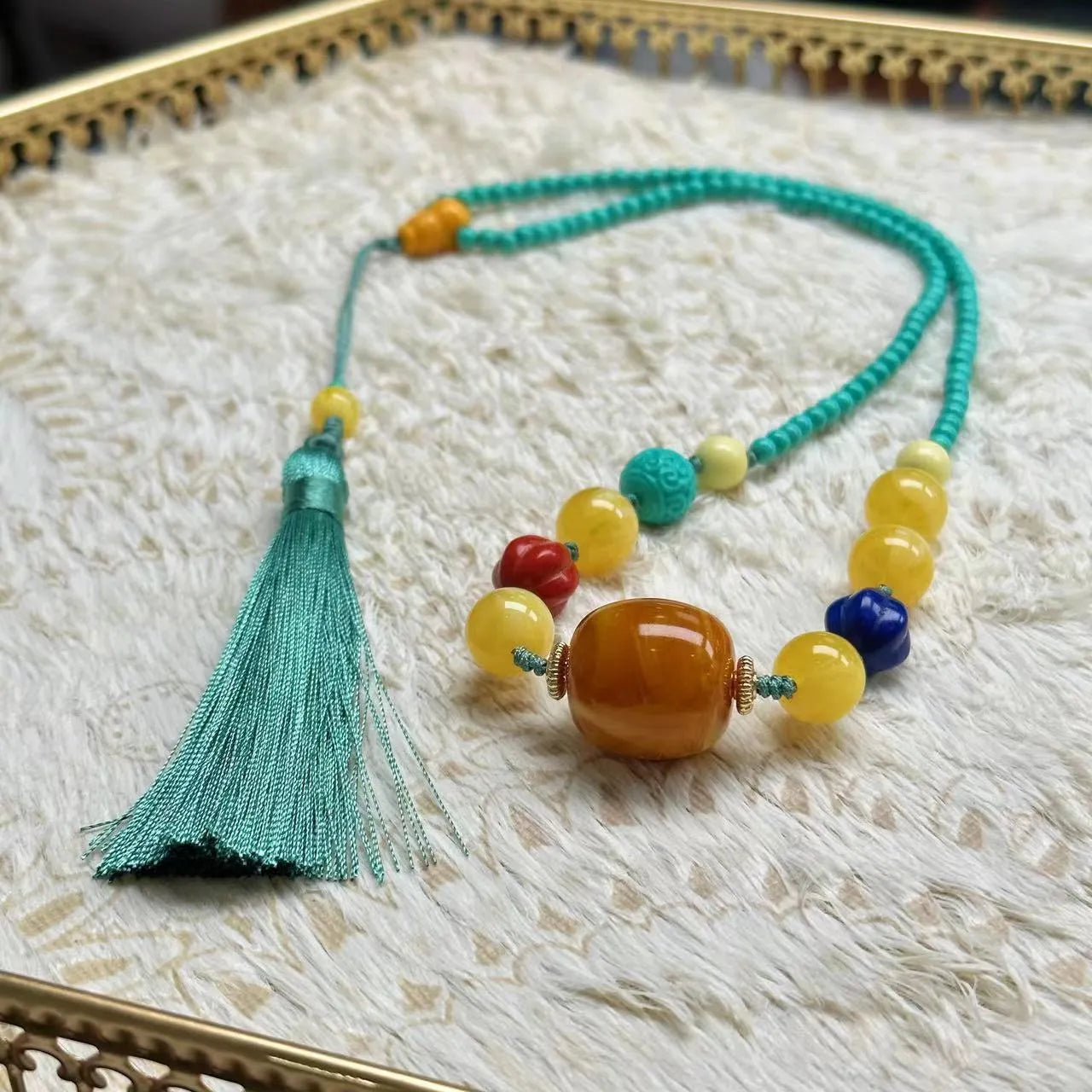Turquoise mesh flower lucky pendant necklace with ball bead chain on a white background