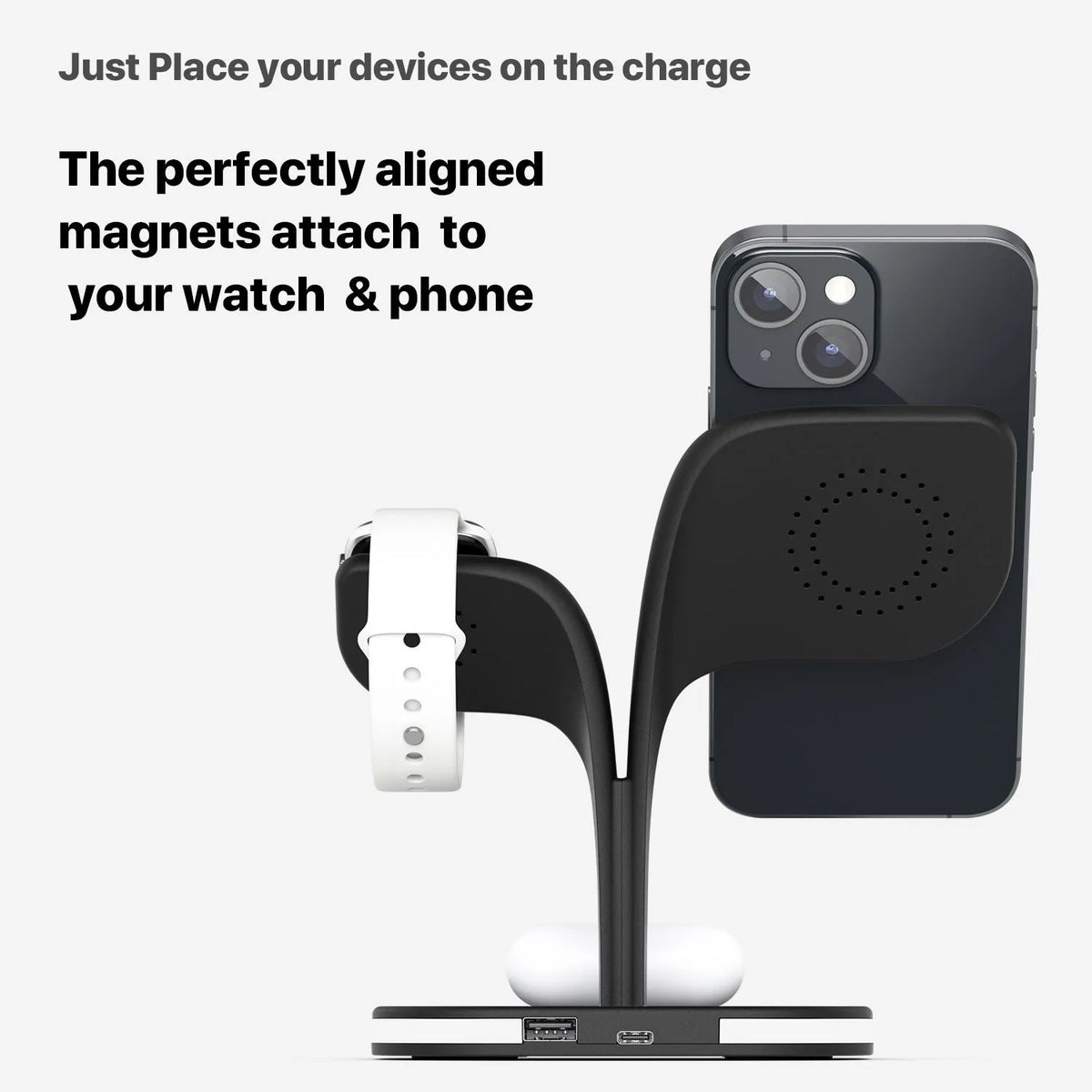 Black and white wireless charging station for phone, watch, and headphones on a desk