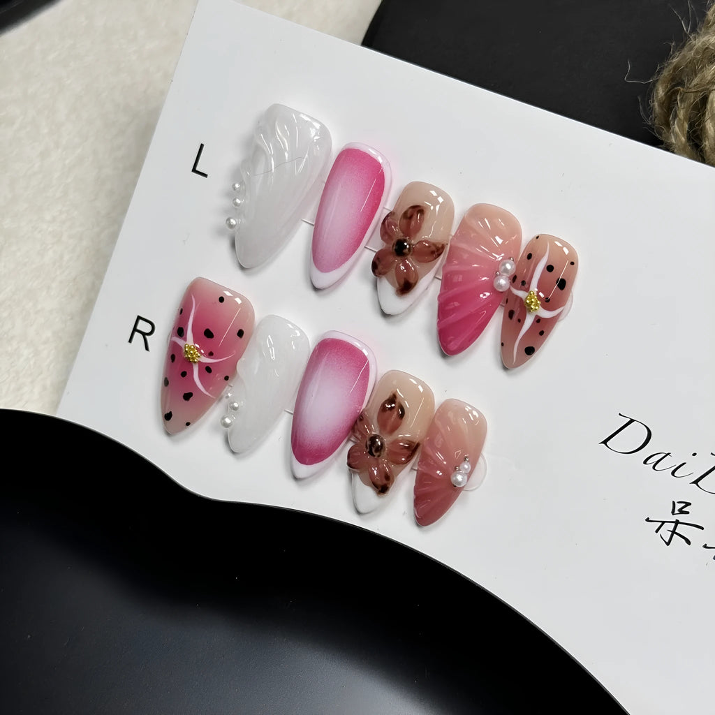 Hand-painted three-dimensional carved nail beauty patches in candy colours on an almond-shaped nail.