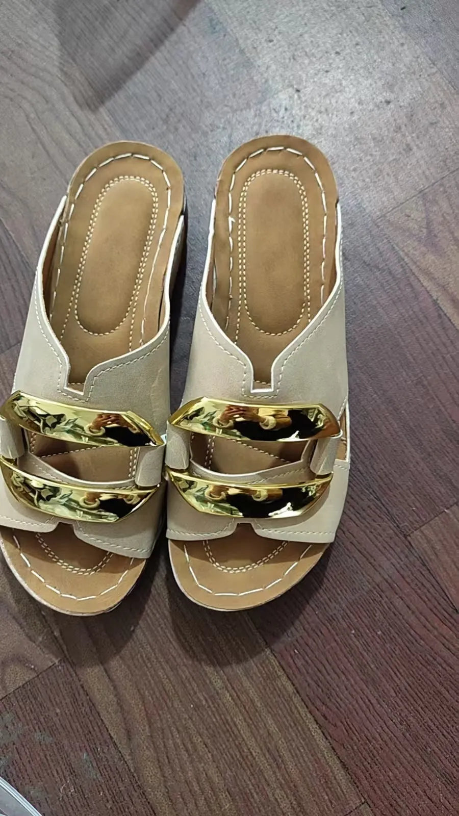 Men's white Roman-style platform sandals with a flat rubber sole and decorative metal details on the strap.
