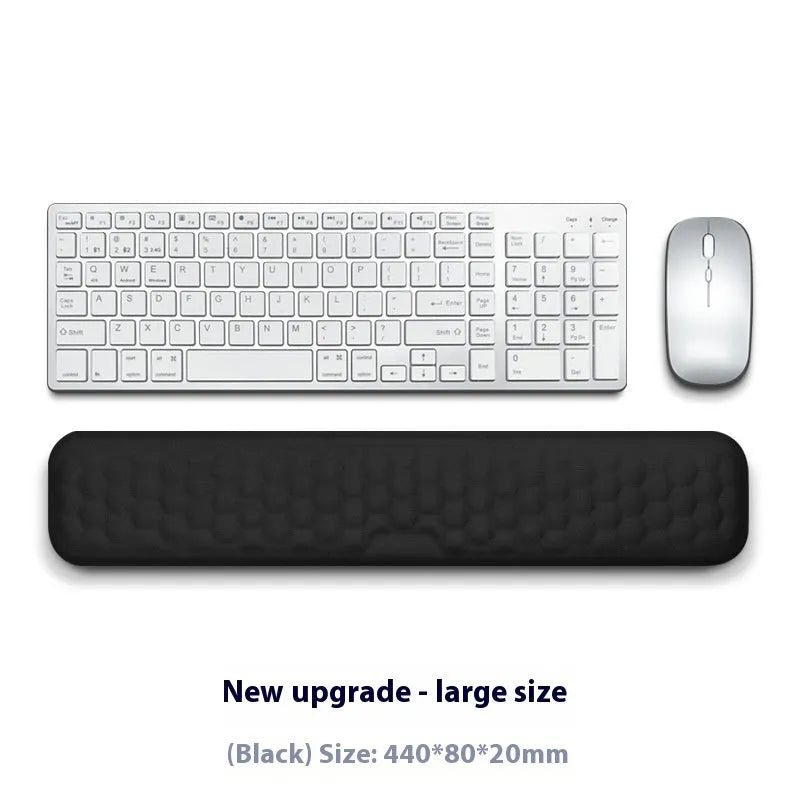 Memory foam mouse wrist pad with silicone bottom in black cloth cover on computer desk