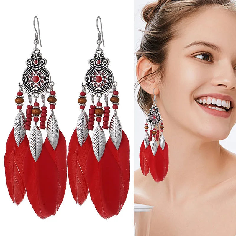 Feather-shaped round drop alloy earrings with leaf design in electroplated finish, showing Bohemian style jewellery.