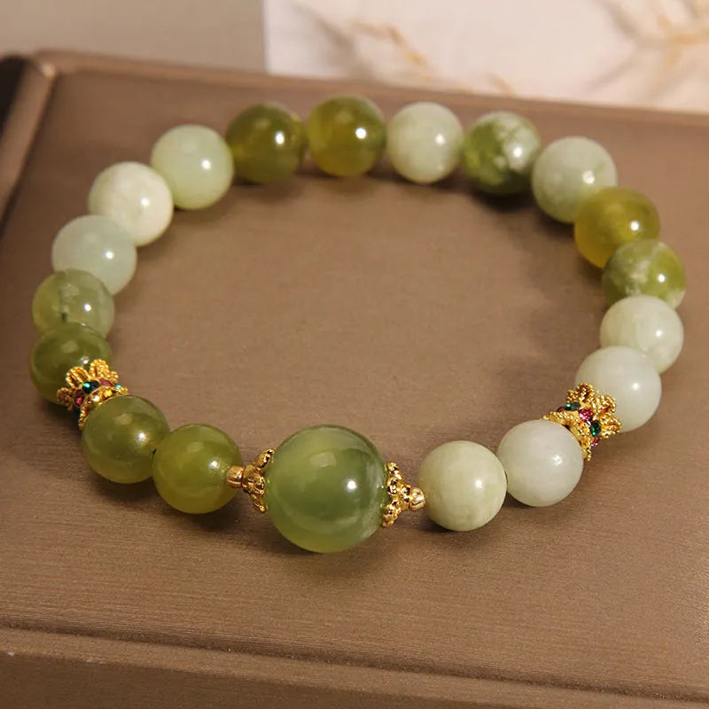 Women's jade bracelet in Xiuyan jade green colour with original design on wrist.